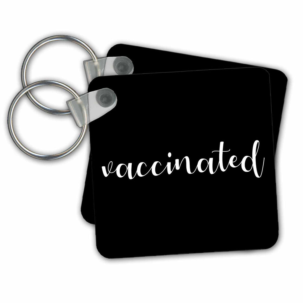Key Chain - Vaccinated. White cursive lettering on black background. Stamp City - typography