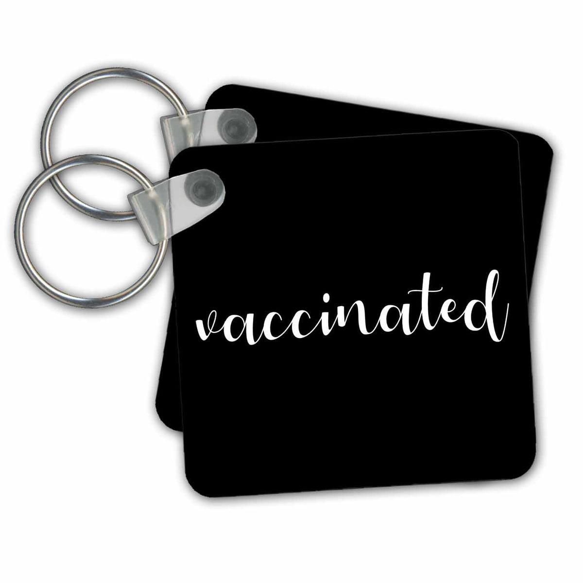Key Chain - Vaccinated. White cursive lettering on black background. Stamp City - typography